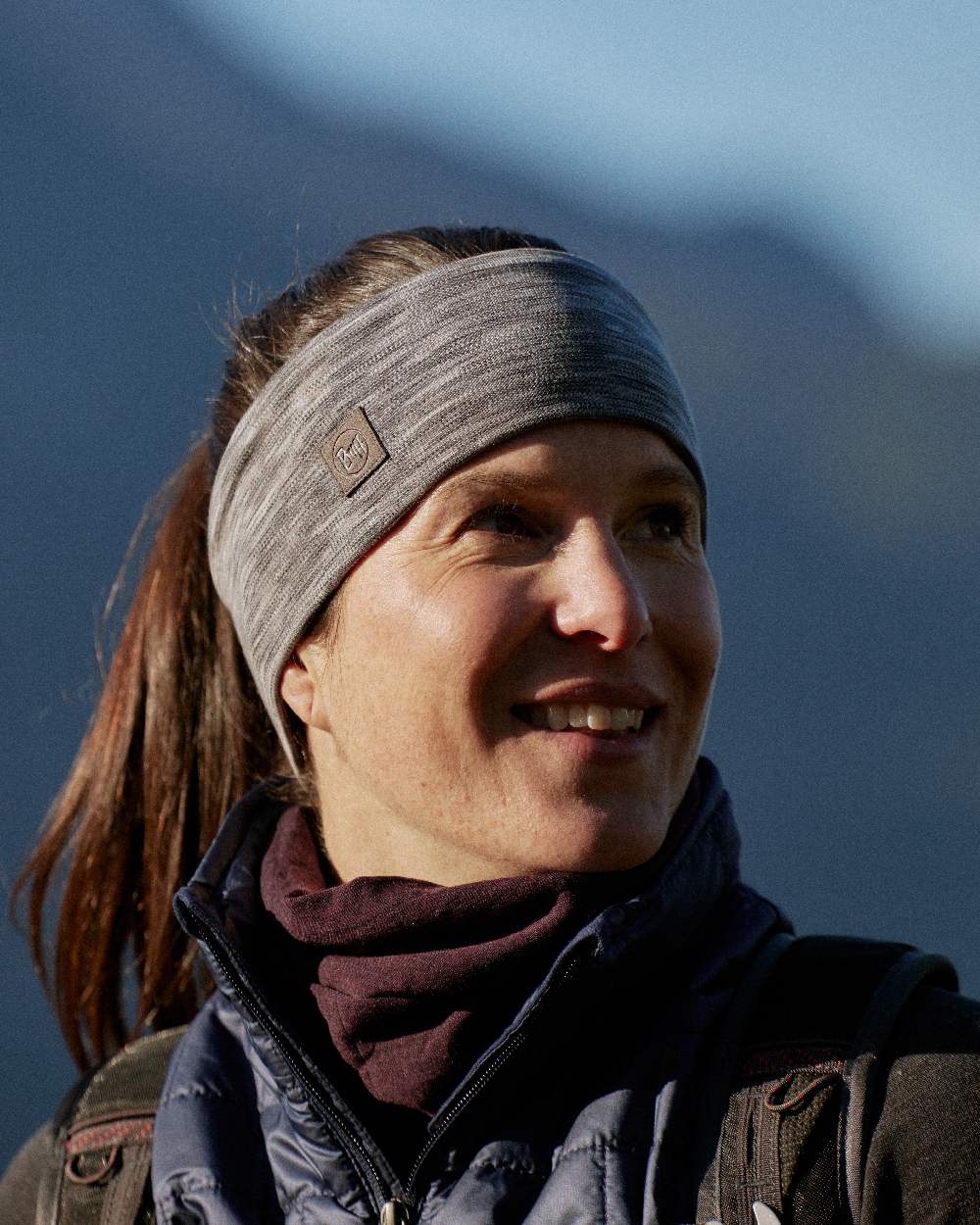 Fog Grey Coloured Buff Merino Wide Headband on blurry background