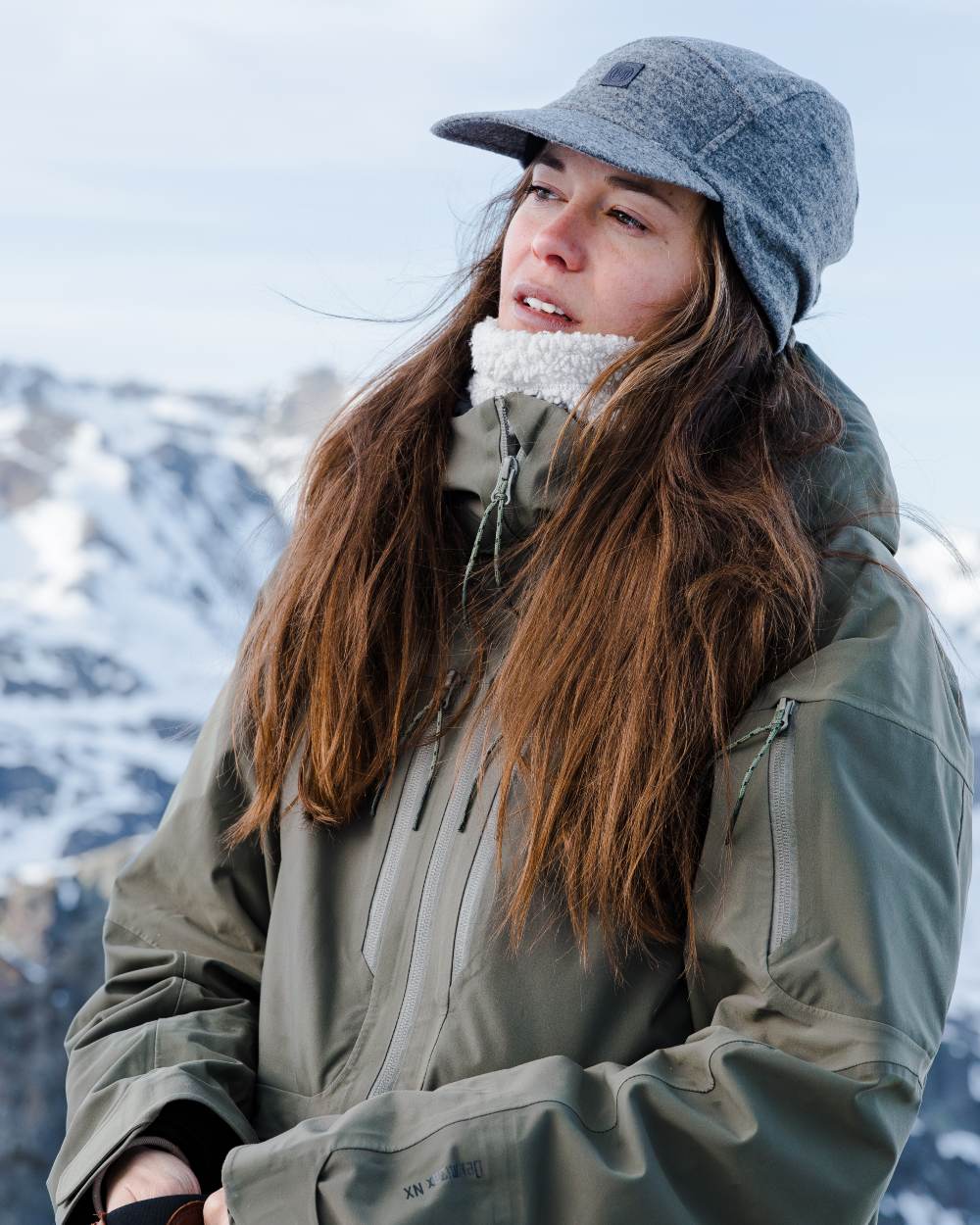 Grey Coloured Buff Pack Merino Fleece Cap on snow background