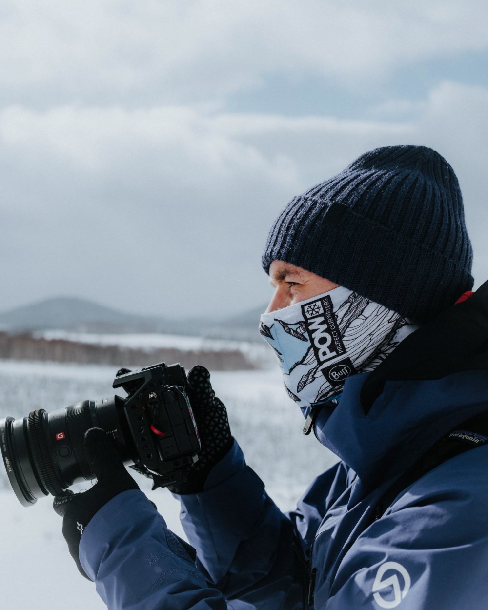 Midnight Coloured Buff Rutger Knitted Beanie on snow background