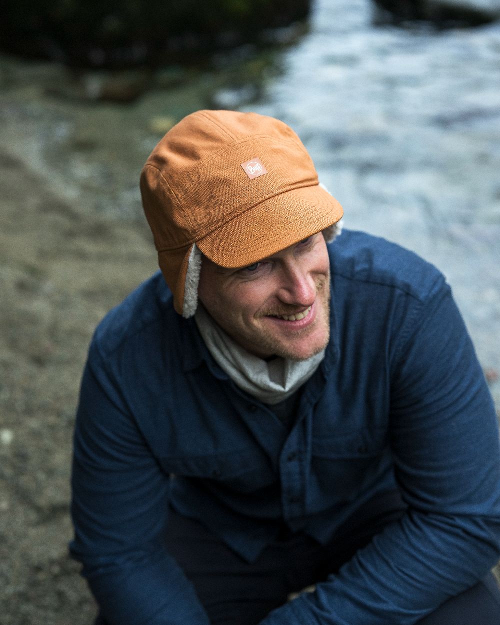 Copper Coloured Buff Simu Fall Line Cap on lake background