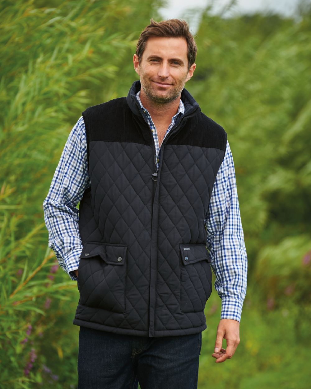 Black coloured Champion Arundel Diamond Quilted Bodywarmer on backyard background