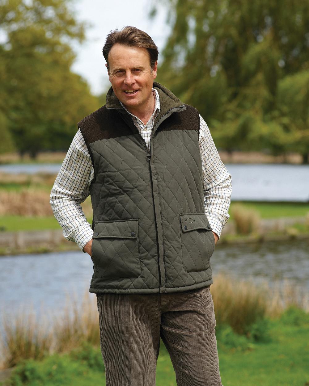 Olive coloured Champion Arundel Diamond Quilted Bodywarmer on pond background