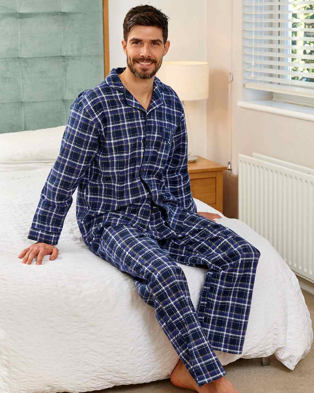 Blue coloured Champion Cambridge Cotton Pyjamas on bedroom background