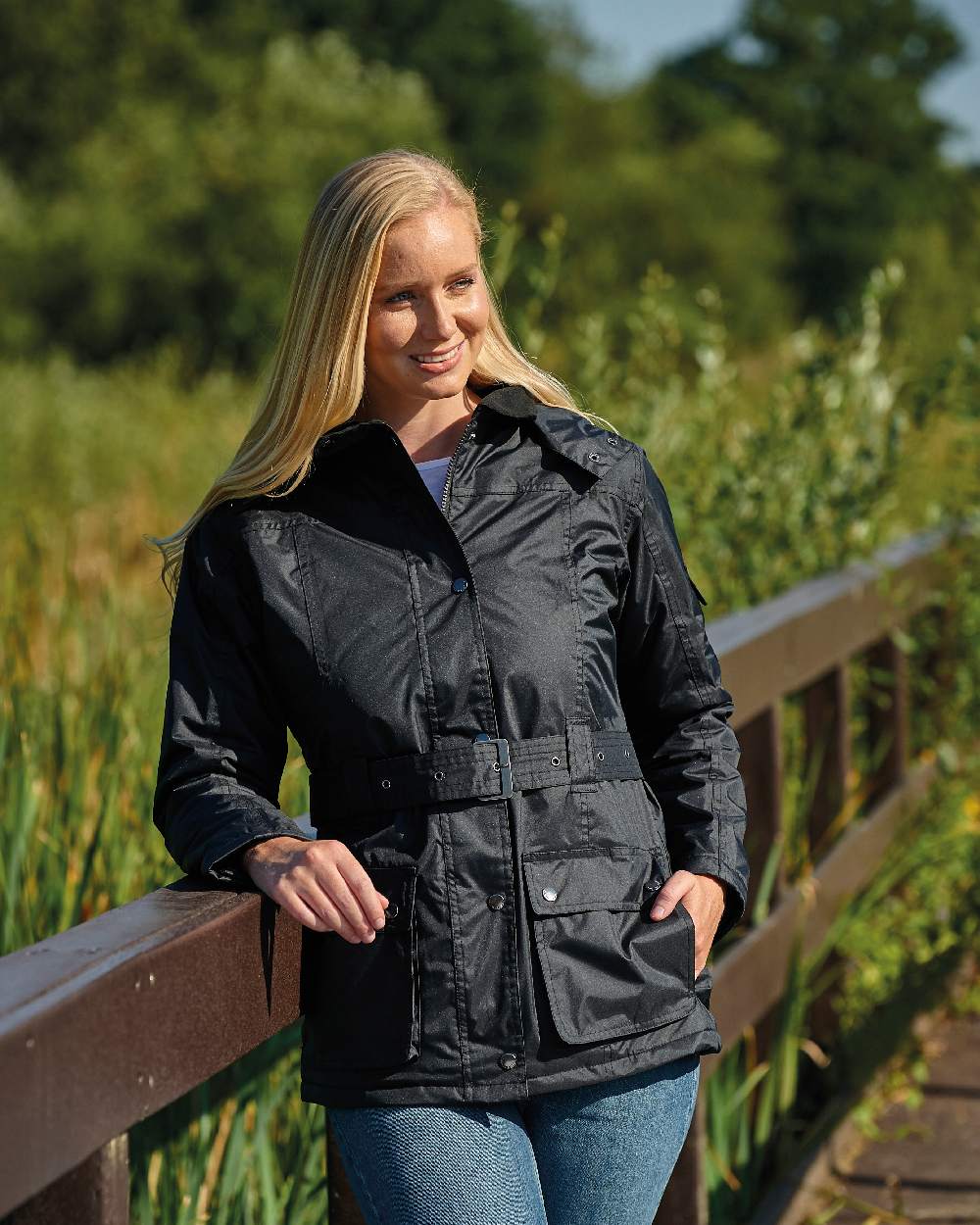 Black coloured Champion Clova Ladies Waterproof Jacket on backyard background