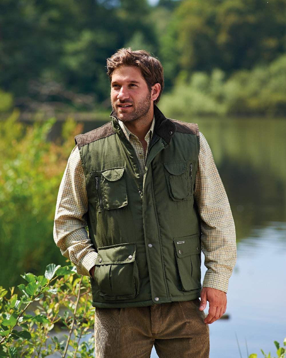 Olive coloured Champion Exmoor Multi Pocket Padded Bodywarmer on river background