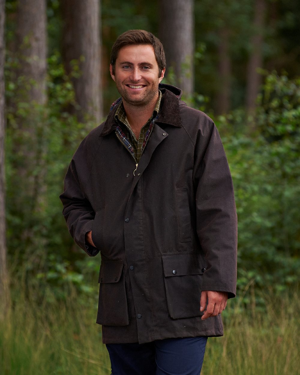 Brown coloured Champion Howick Waxed Cotton Jacket on forest background
