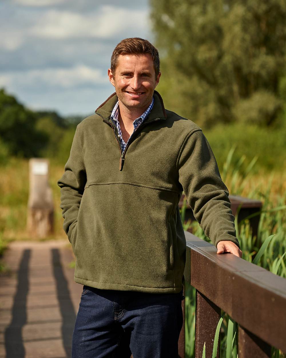 Olive coloured Champion Oban Half Zip Fleece on forest background