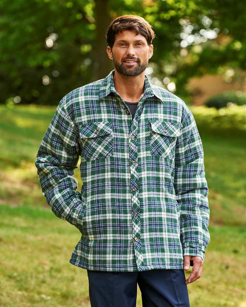 Green coloured Champion Pennine Fleece Lined Shirt on lawn background