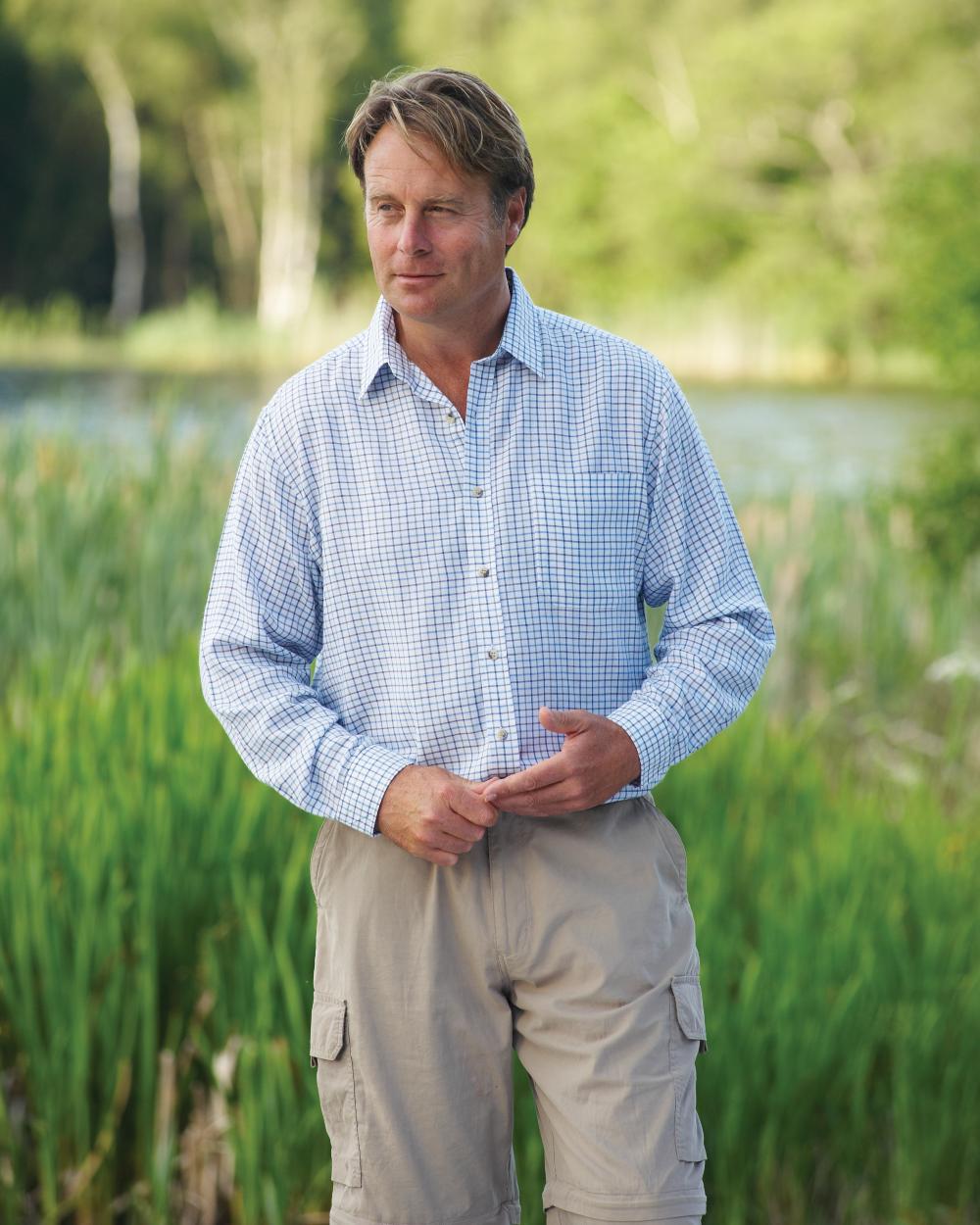 Blue coloured Champion Tattersall Check Shirt on lakeside background