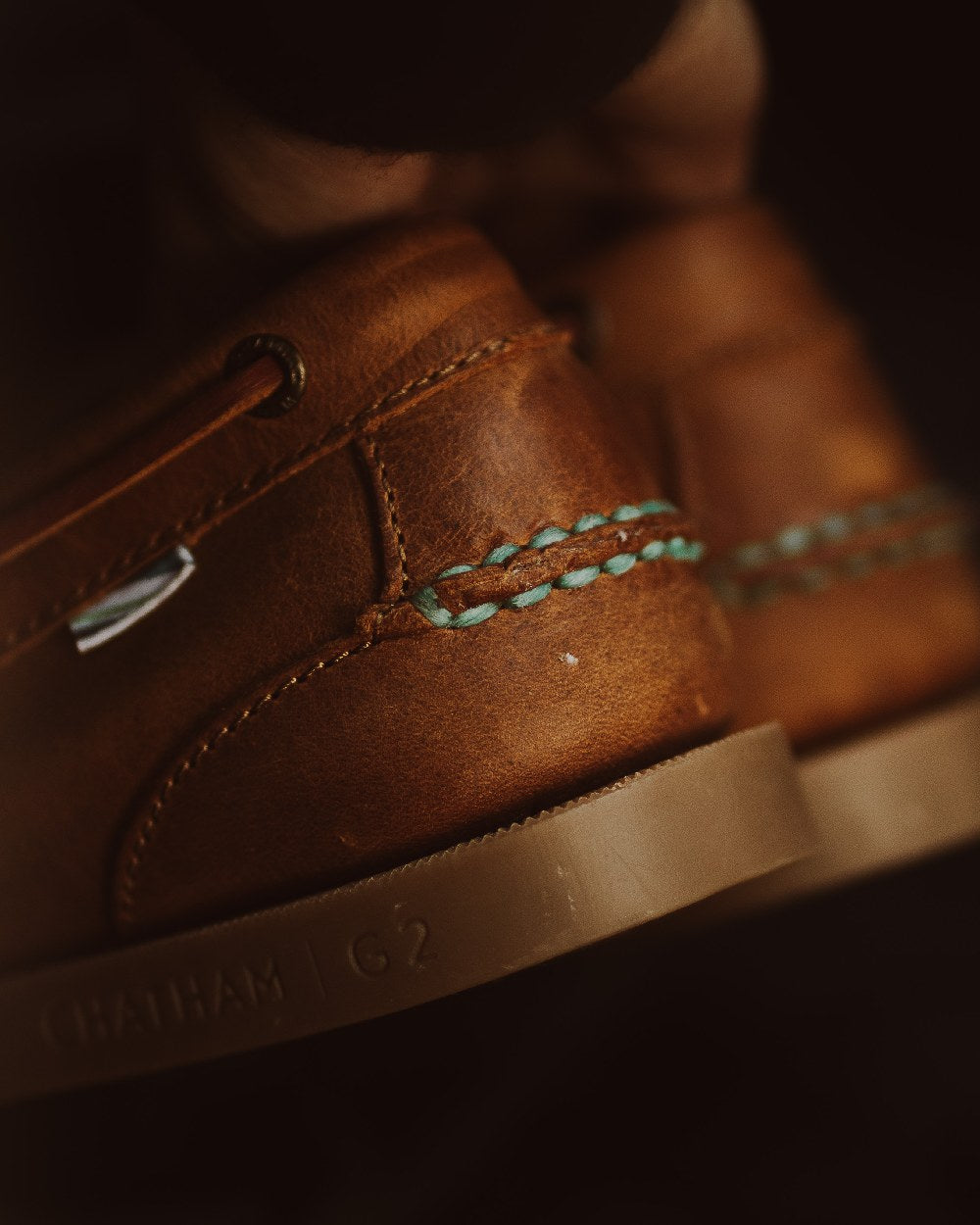 Walnut Coloured Chatham Mens The Deck II G2 Premium Leather Boat Shoes on blurry background