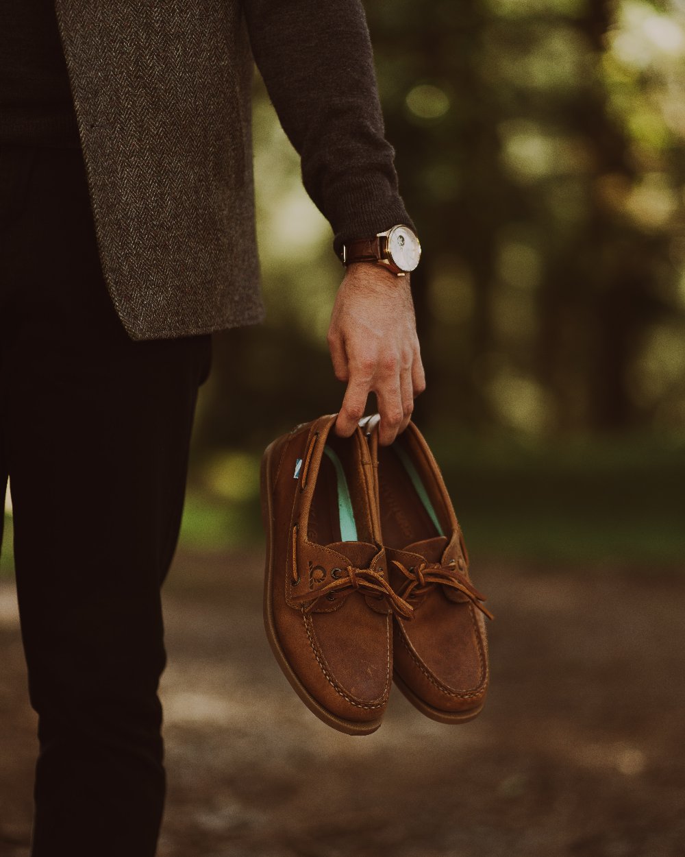 Walnut Coloured Chatham Mens The Deck II G2 Premium Leather Boat Shoes on blurry background