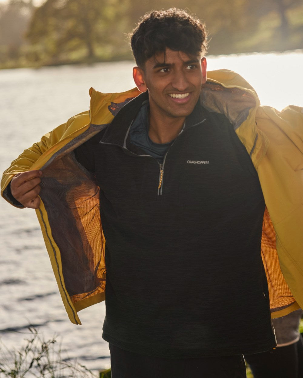 Black coloured Craghoppers Mens Esk Half Zip Fleece on sea background