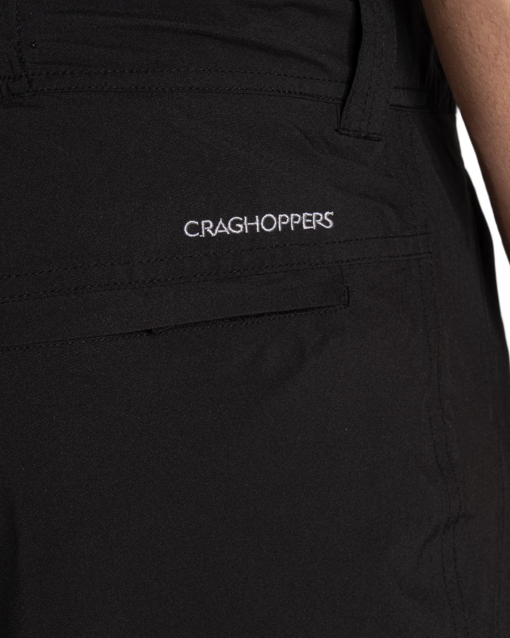Black coloured Craghoppers Mens Indus Waterproof Lightweight Cargo Trousers on white background