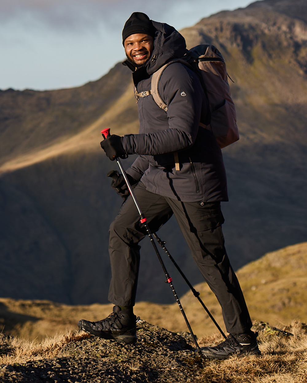 Black coloured Craghoppers Mens Indus Waterproof Lightweight Cargo Trousers on mountain background