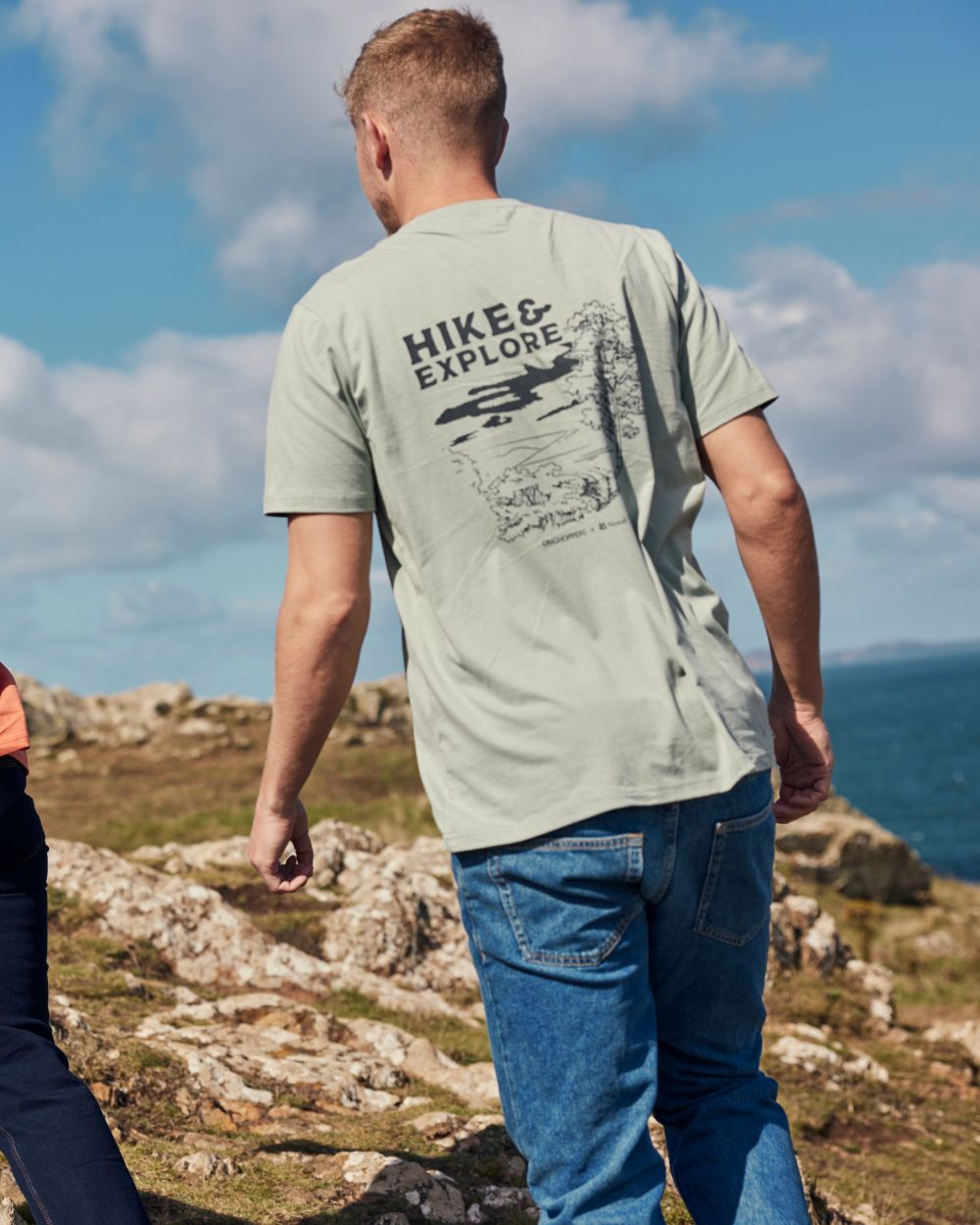 Soft Sage coloured Craghoppers Mens National Trust Sabden Short Sleeved T-Shirt on coastal background