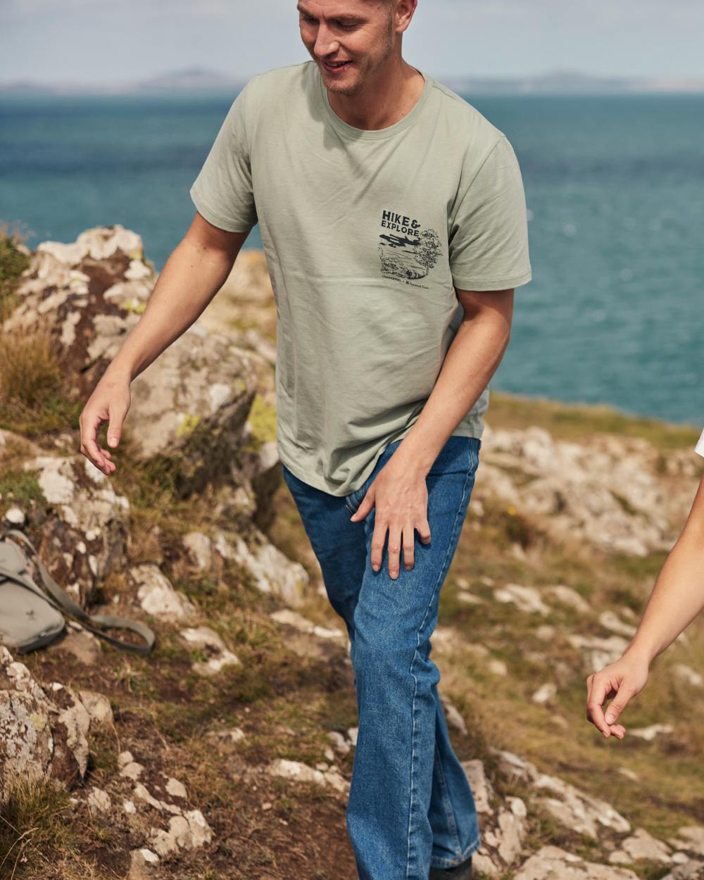 Soft Sage coloured Craghoppers Mens National Trust Sabden Short Sleeved T-Shirt on coastal background
