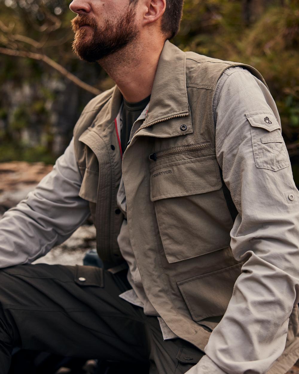 Pebble coloured Craghoppers Mens NosiLife Adventure Gilet IV on blurry background