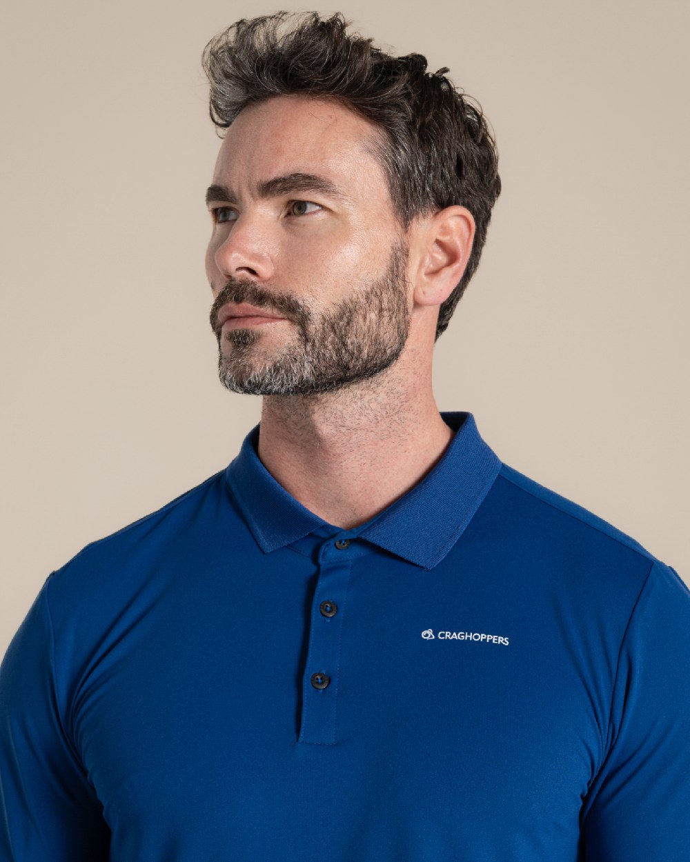 Deep Marina Coloured Craghoppers mens Nosilife Bramshaw Long Sleeved Polo Top on Beige Background