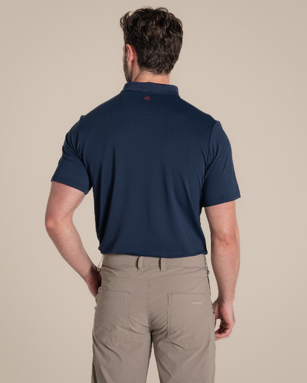 Blue Navy Coloured Craghoppers Mens Nosilife Bramshaw Short Sleeved Polo Top on Beige Background