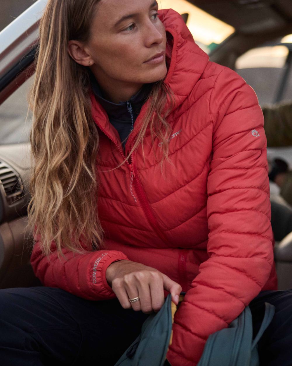 Dawn Red Coloured Craghoppers Womens Compresslite IX Hooded Insulating Jacket on car background