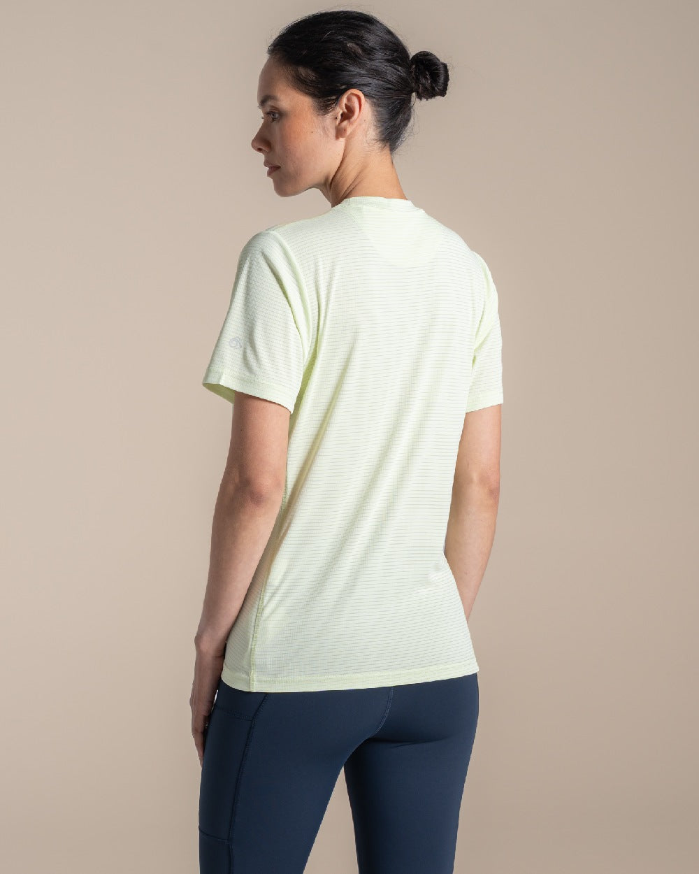 Pear Drop coloured Craghoppers Womens NosiLIfe SolarShield+ Short Sleeved T-Shirt on beige background