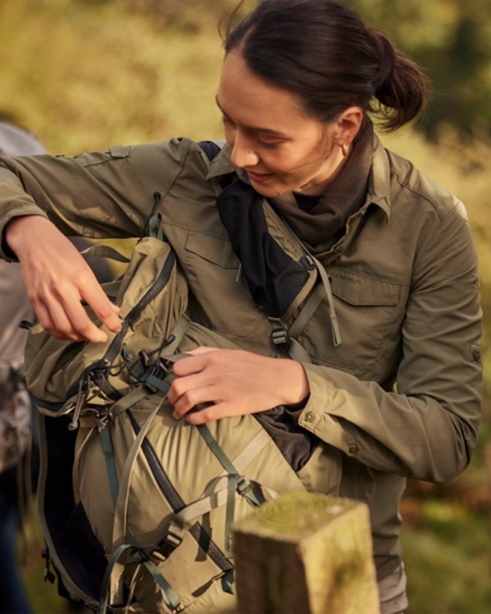 Wild Olive coloured Craghoppers Womens NosiLife Adventure Long Sleeved Shirt III on forest background