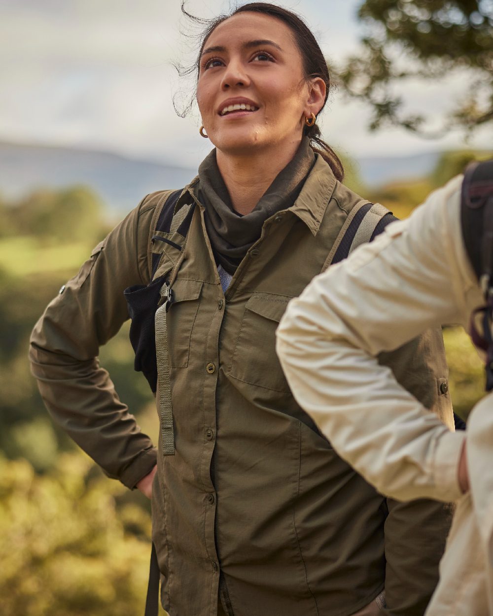 Wild Olive coloured Craghoppers Womens NosiLife Adventure Long Sleeved Shirt III on forest background