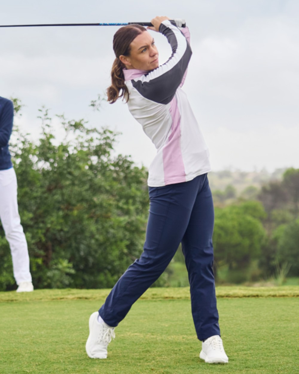 Blue Navy coloured Craghoppers Womens Nosilife Milla Golf Trousers on grass background