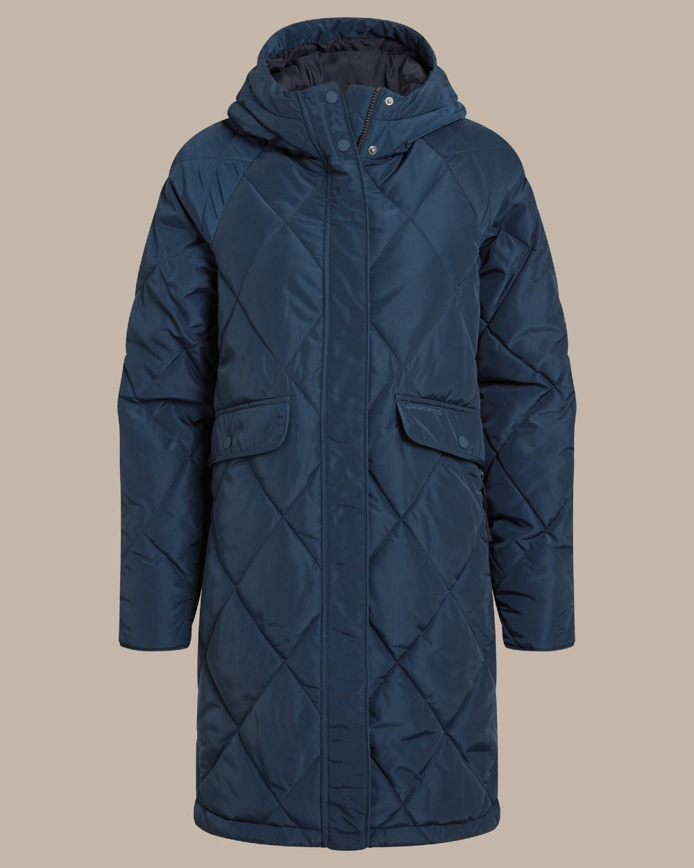 Deep teal blue colour parka, against a solid beige studio background.