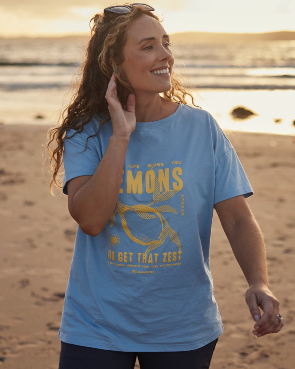 Nimbus Blue Coloured Craghoppers Womens Yago Short Sleeved Top on beach Background