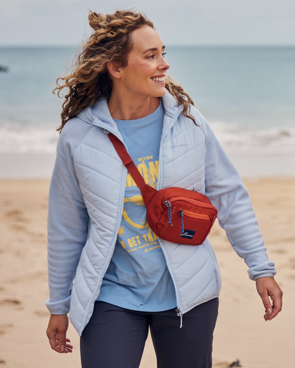 Nimbus Blue coloured Craghoppers Womens Zayas Hybrid Insulating Jacket on sea background