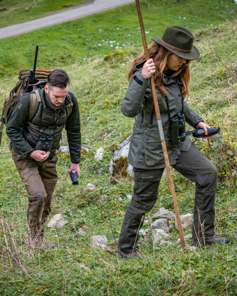 Green Coloured Deerhunter Adventurer Felt Hat on land background