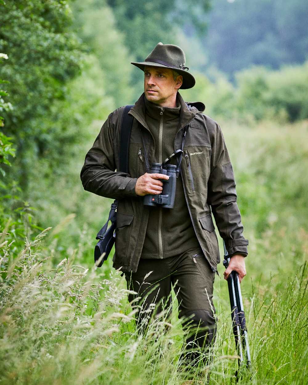 Olive Night Melange coloured Deerhunter Chasse Trousers on forest background