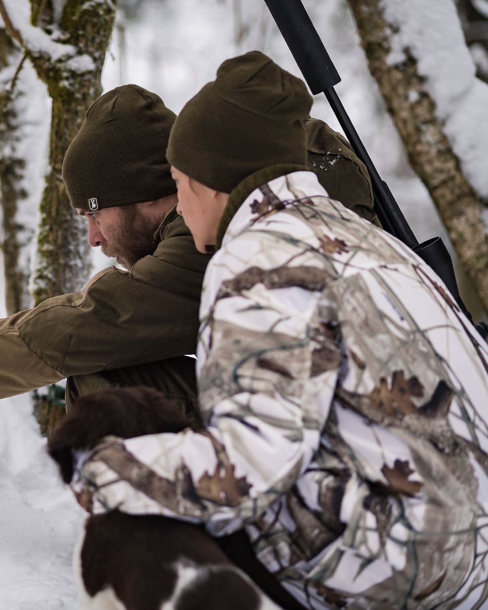 Orange Green coloured Deerhunter Cumberland Reversible Beanie on snow background
