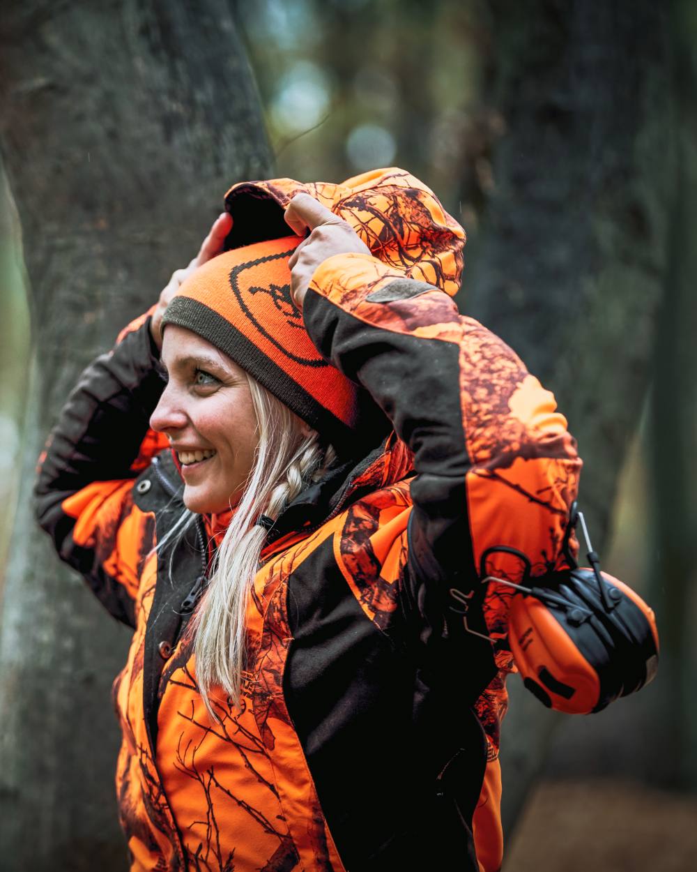 Orange Green coloured Deerhunter Cumberland Reversible Beanie on tree background