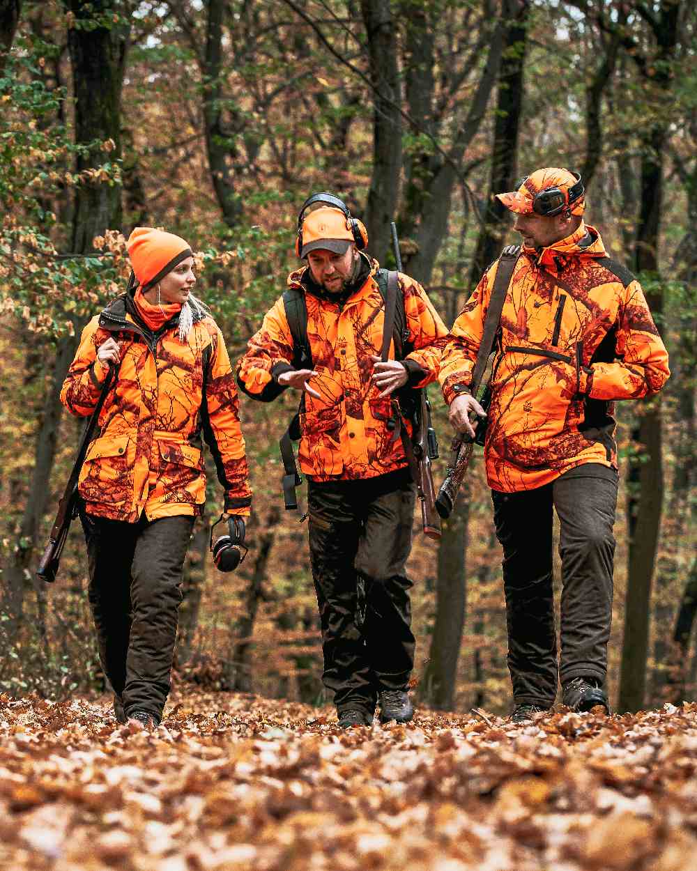 Orange Green coloured Deerhunter Cumberland Reversible Beanie on forest background