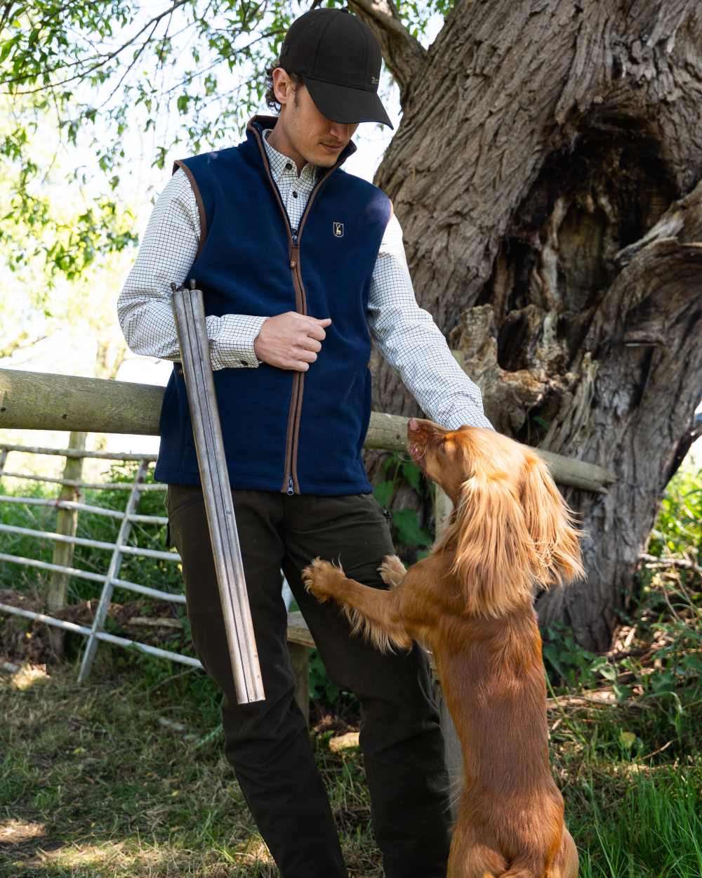 Dark Blue coloured Deerhunter Cumbria Fleece Waistcoat on forest background