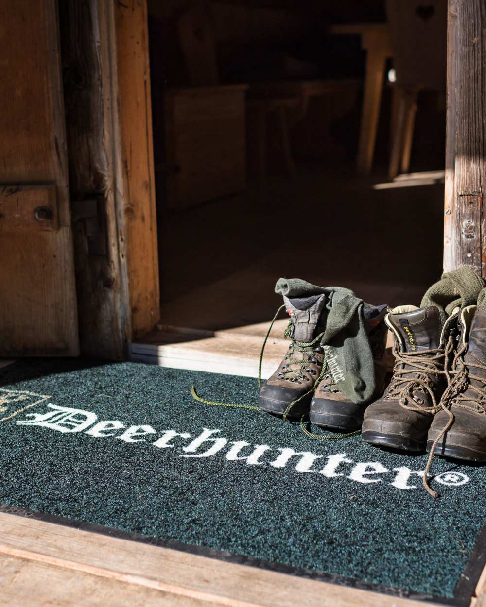 Green coloured Deerhunter Door Mat on door background