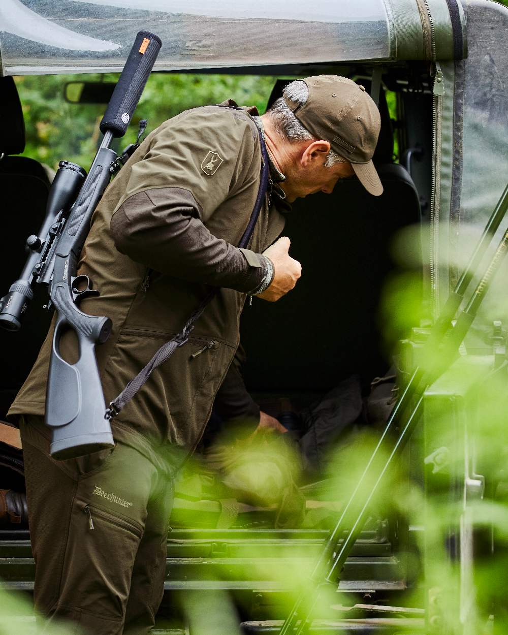 Art Green coloured Deerhunter Excape Light Jacket on jeep background