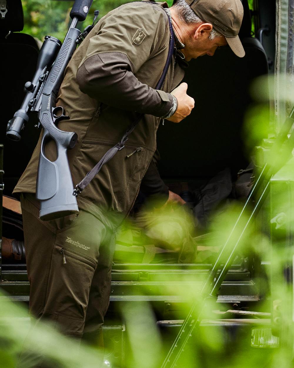 Art Green coloured Deerhunter Excape Light Trousers on jeep background