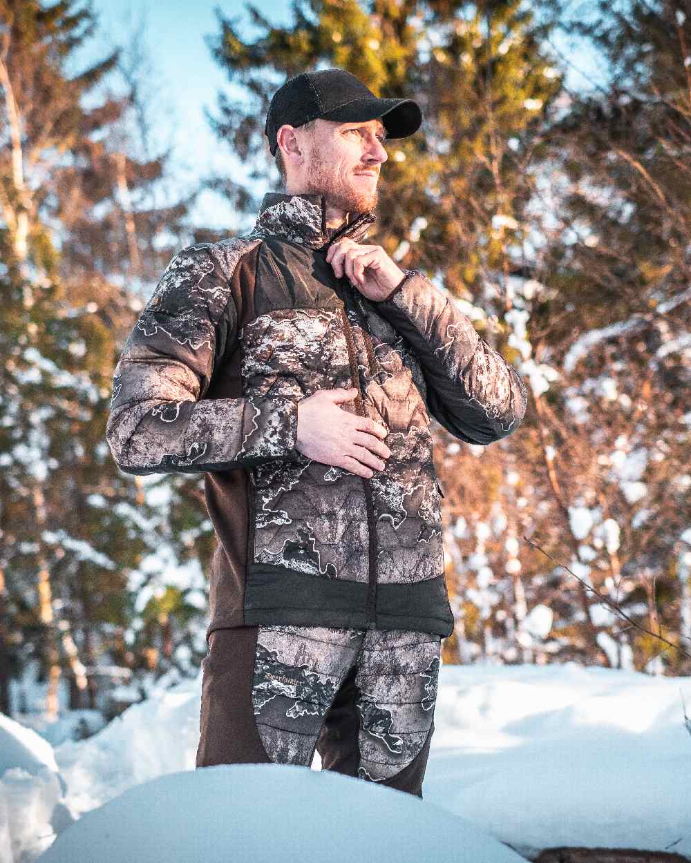 Realtree Excape coloured Deerhunter Excape Quilted Trousers on snow background