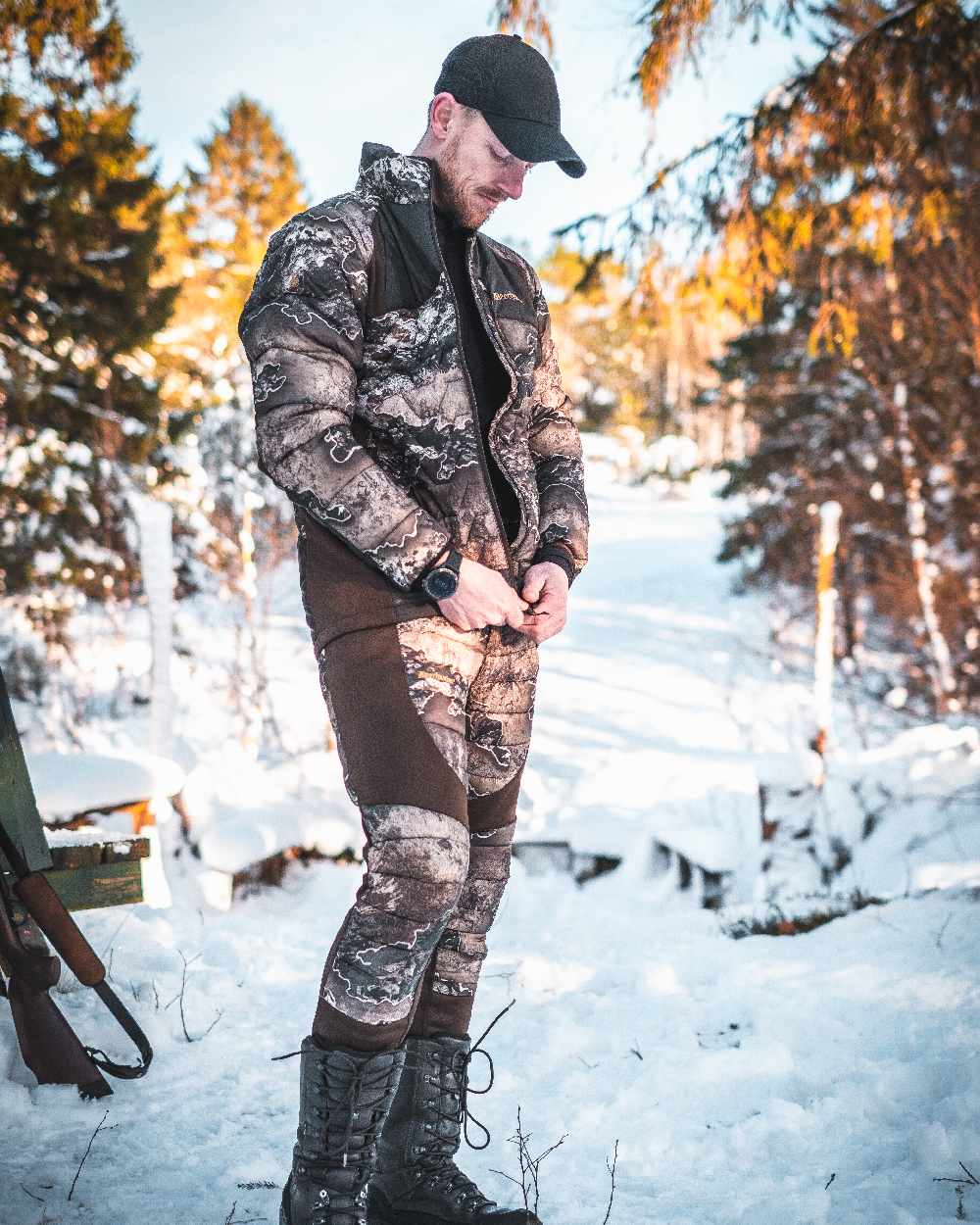 Realtree Excape coloured Deerhunter Excape Quilted Trousers on snow background