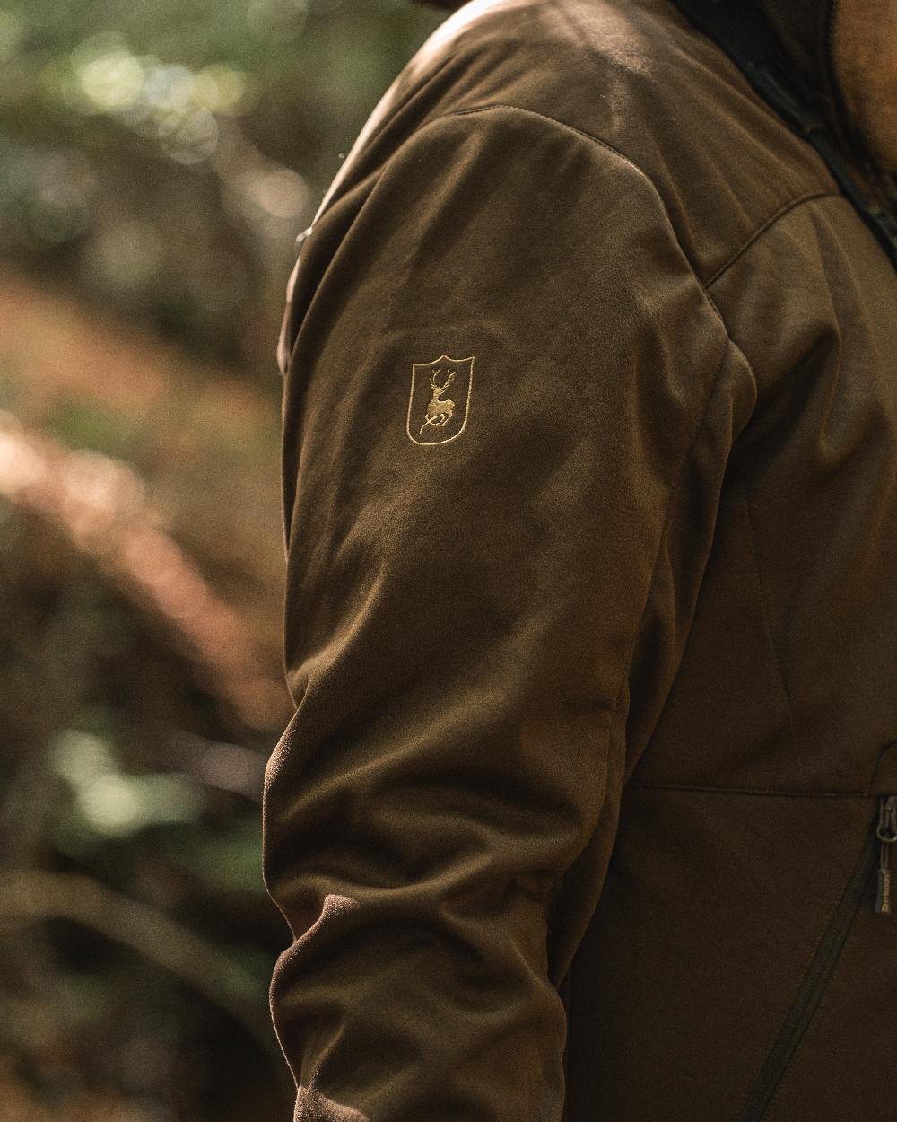 Art Green coloured Deerhunter Excape Softshell Jacket on blurry background