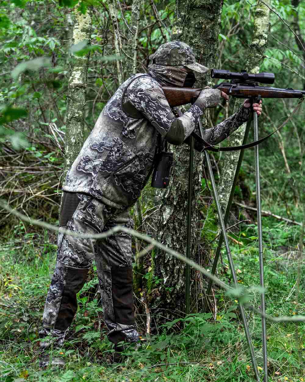 Realtree Excape coloured Deerhunter Excape Softshell Trousers on forest background