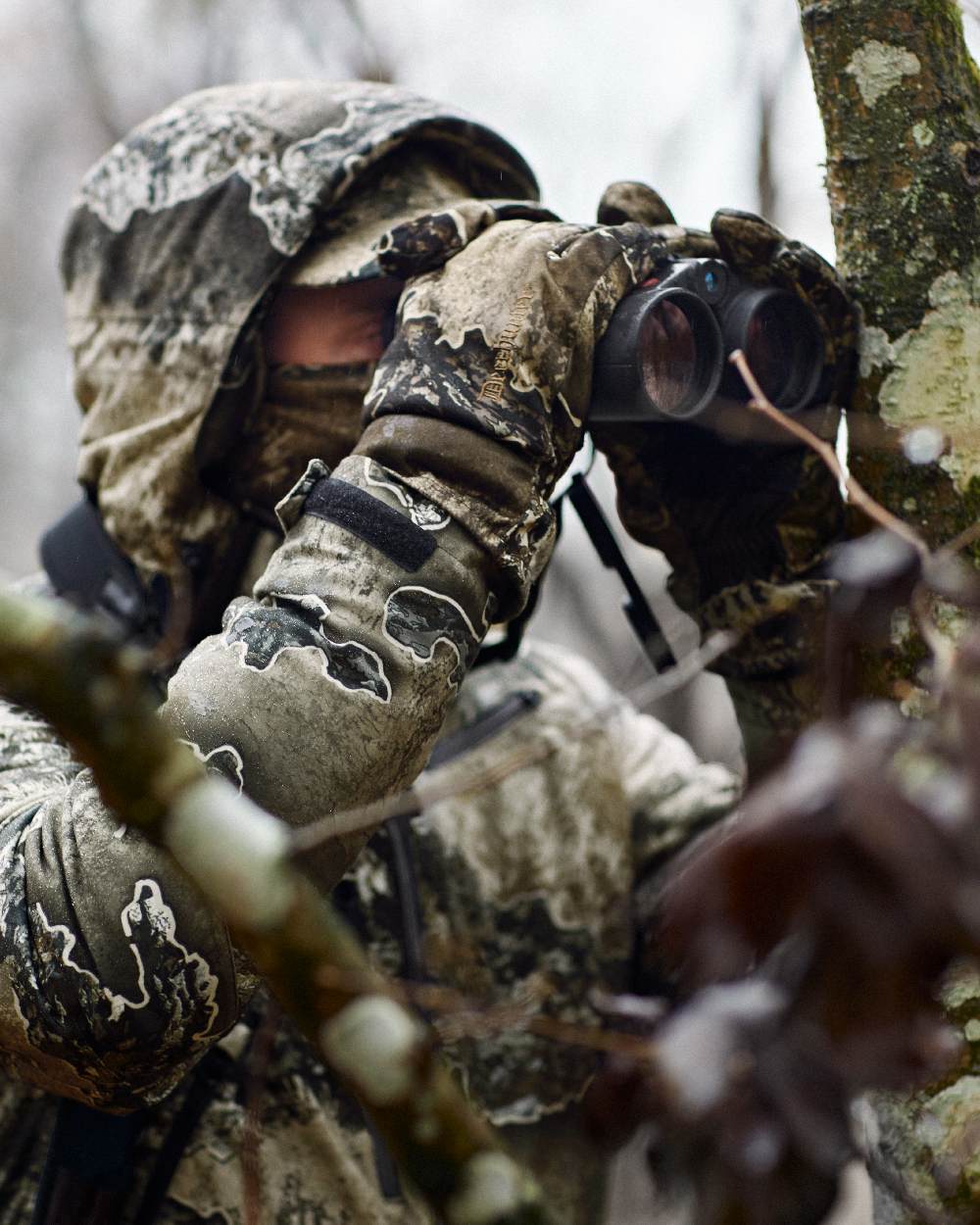 Realtree Excape coloured Deerhunter Excape Winter Cap on blurry background