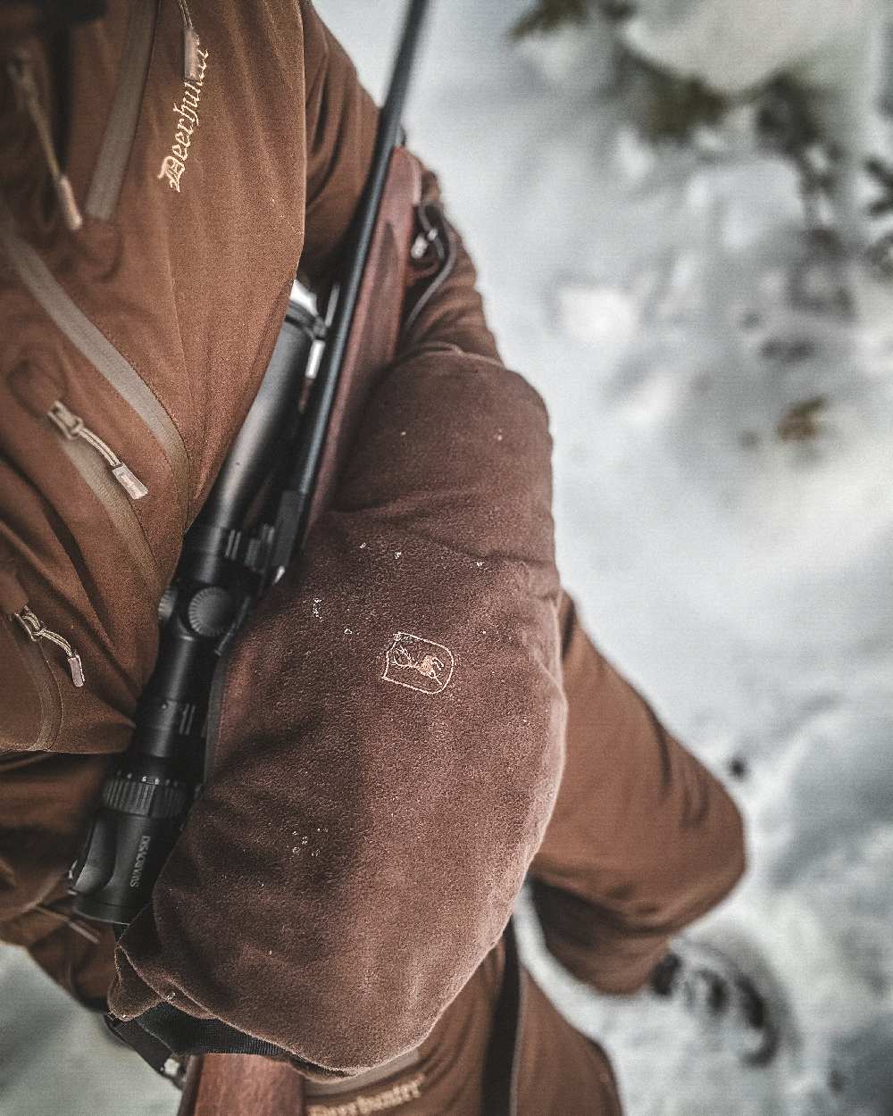 Art Green coloured Deerhunter Excape Winter Waterproof Jacket on snow background