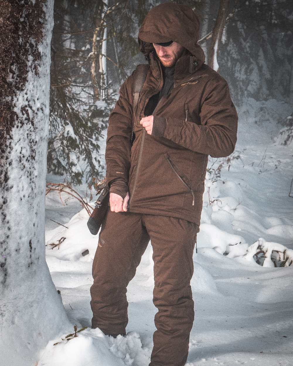 Art Green coloured Deerhunter Excape Winter Waterproof Jacket on snow background