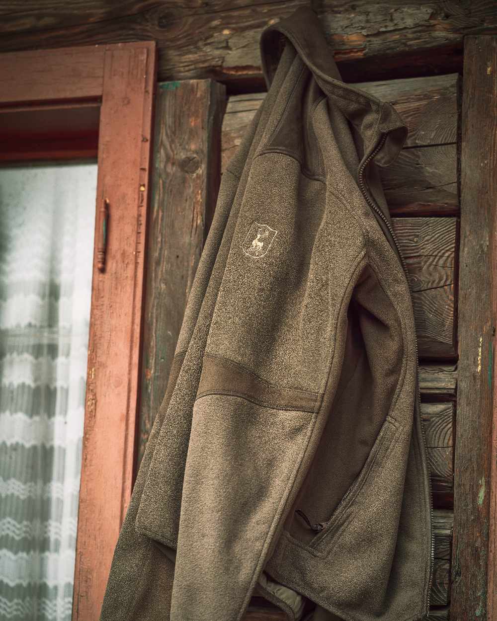 Graphite Green coloured Deerhunter Gamekeeper Bonded Fleece Jacket on wooden background