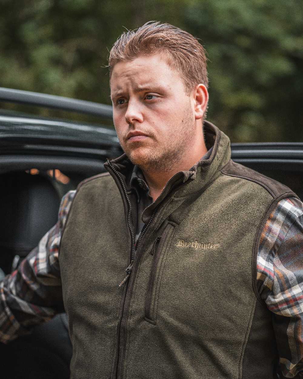 Graphite Green coloured Deerhunter Gamekeeper Bonded Fleece Waistcoat on blurry background
