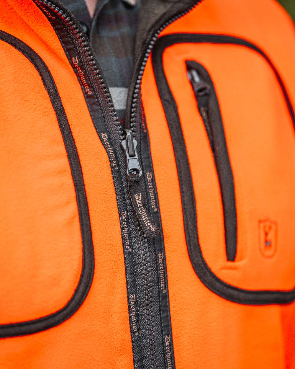 Canteen Orange coloured Deerhunter Gamekeeper Reversible Bonded Fleece Jacket on blurry background